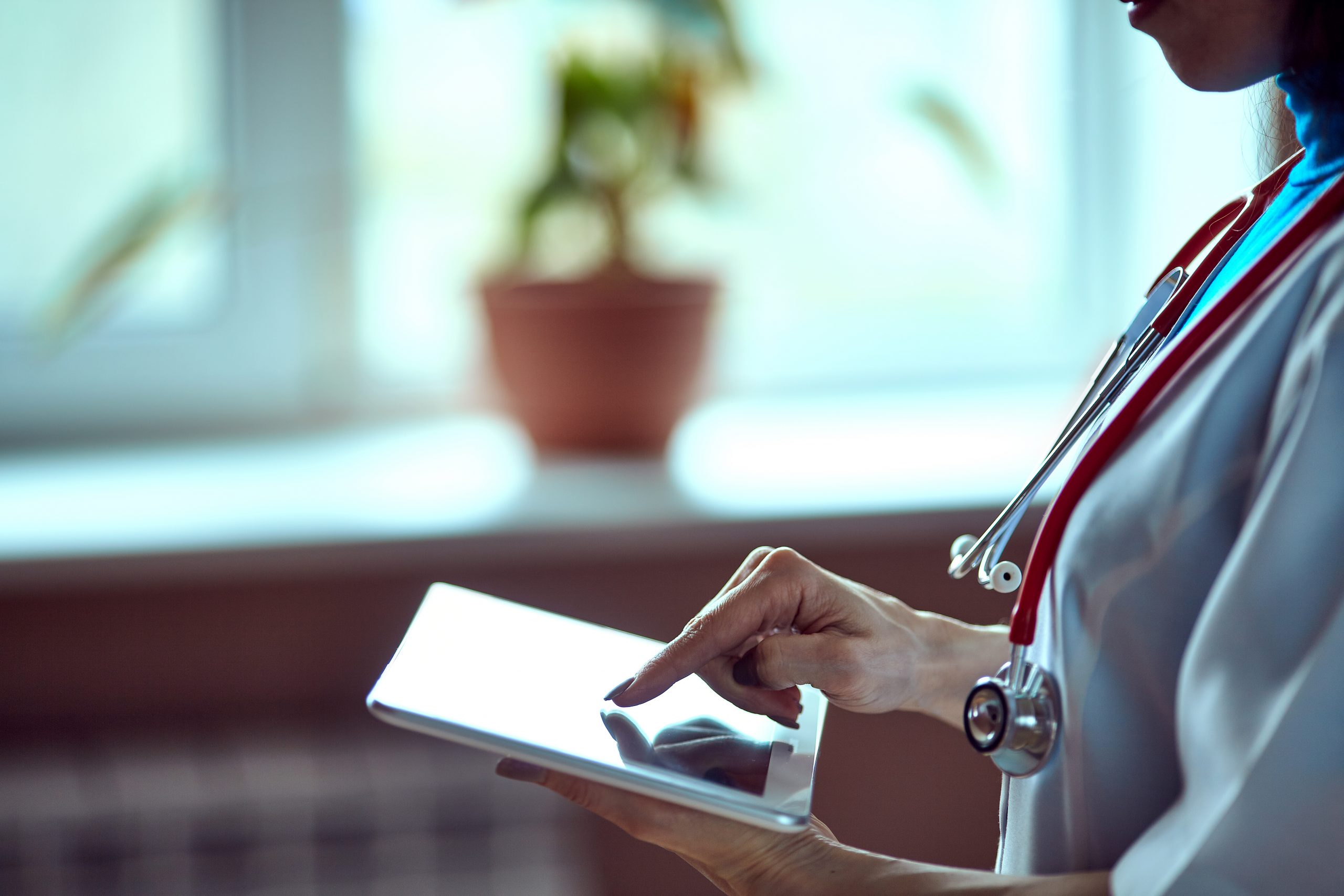 Doctor using tablet device