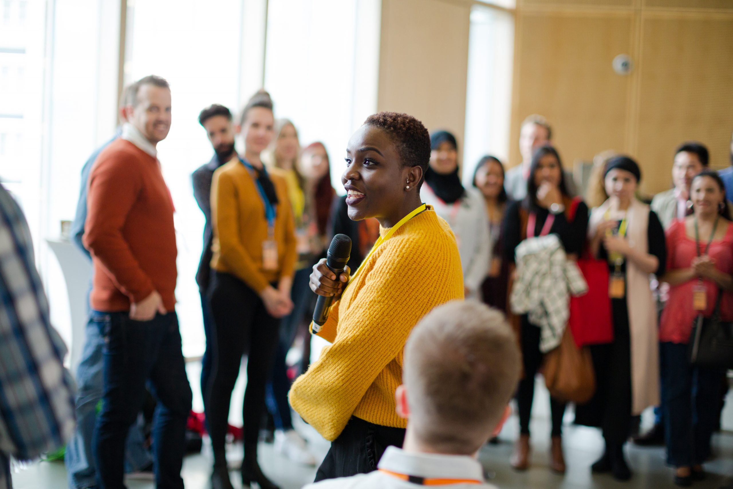 Group discussion with woman speaking on microphone